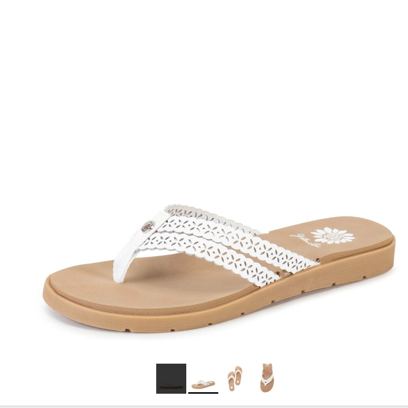 White sandal with tan sole on a white background